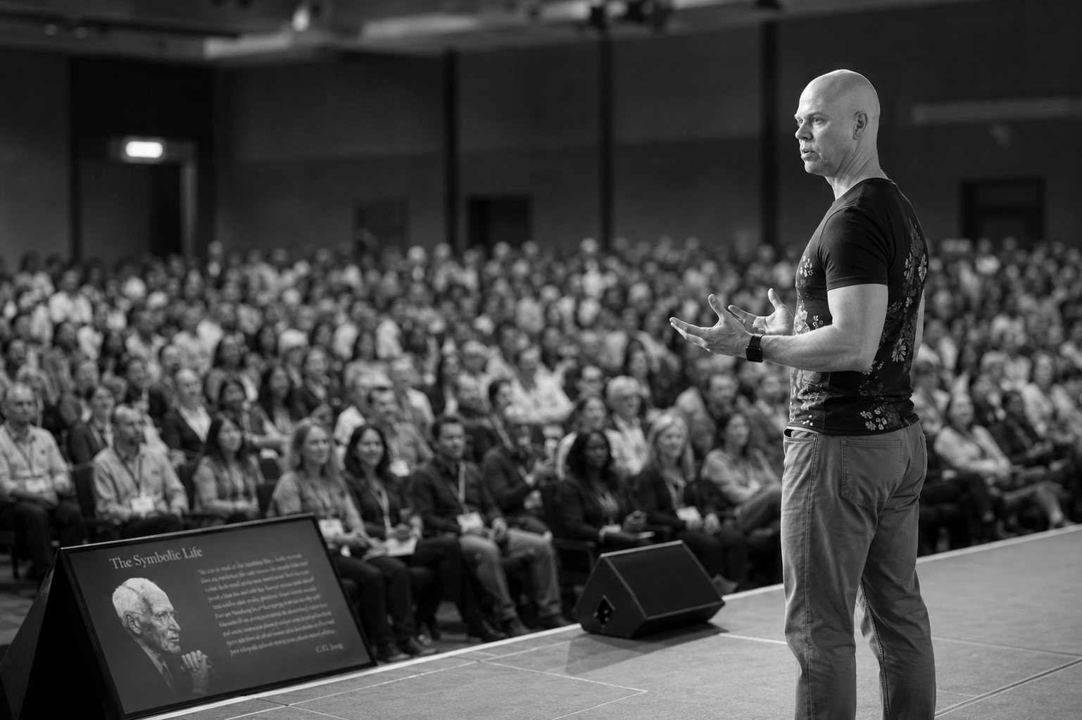 Bradley McDevitt delivering a keynote to a full auditorium